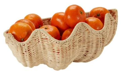 Wide shell-shaped rattan fruit bowl holding whole oranges - HNH BK2535