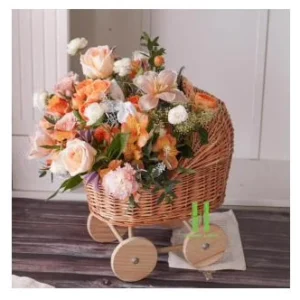 Rattan flower basket on wooden wheels filled with roses - HNH BK2530