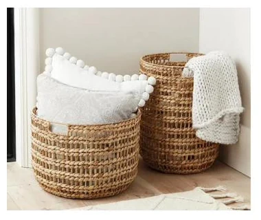 Pair of water hyacinth floor baskets holding cushions and throws - HNH BK25166